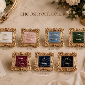 May include: Seven square ring boxes with ornate gold frames and velvet inserts in white, pink, light blue, green, red, navy blue, and black. Each box features two horizontal slots for rings and the text CHOOSE YOUR COLOR at the top.