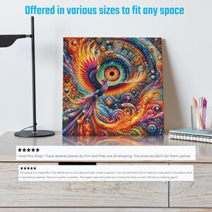 May include: A colorful abstract painting of a phoenix with a large eye in the center. The painting is on a canvas and is framed. The painting is on a wooden table with a lamp, books, and a cup.