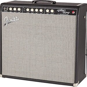 May include: A black Fender Vibro-King 20th Anniversary Edition guitar amplifier. The amplifier has a silver speaker grill, a black handle, and multiple knobs and inputs. The Fender logo is visible on the front.
