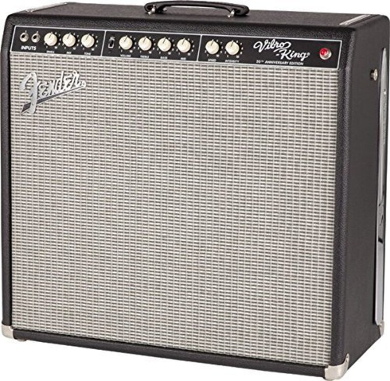 May include: A black Fender Vibro-King 20th Anniversary Edition guitar amplifier. The amplifier has a silver speaker grill, a black handle, and multiple knobs and inputs. The Fender logo is visible on the front.