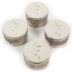May include: Set of four silver guitar knobs with a raised "G" logo on each knob.
