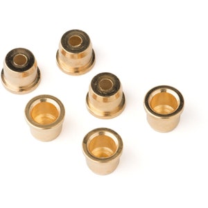 May include: Six gold-colored metal candle holders. The candle holders are round and have a small lip around the top.