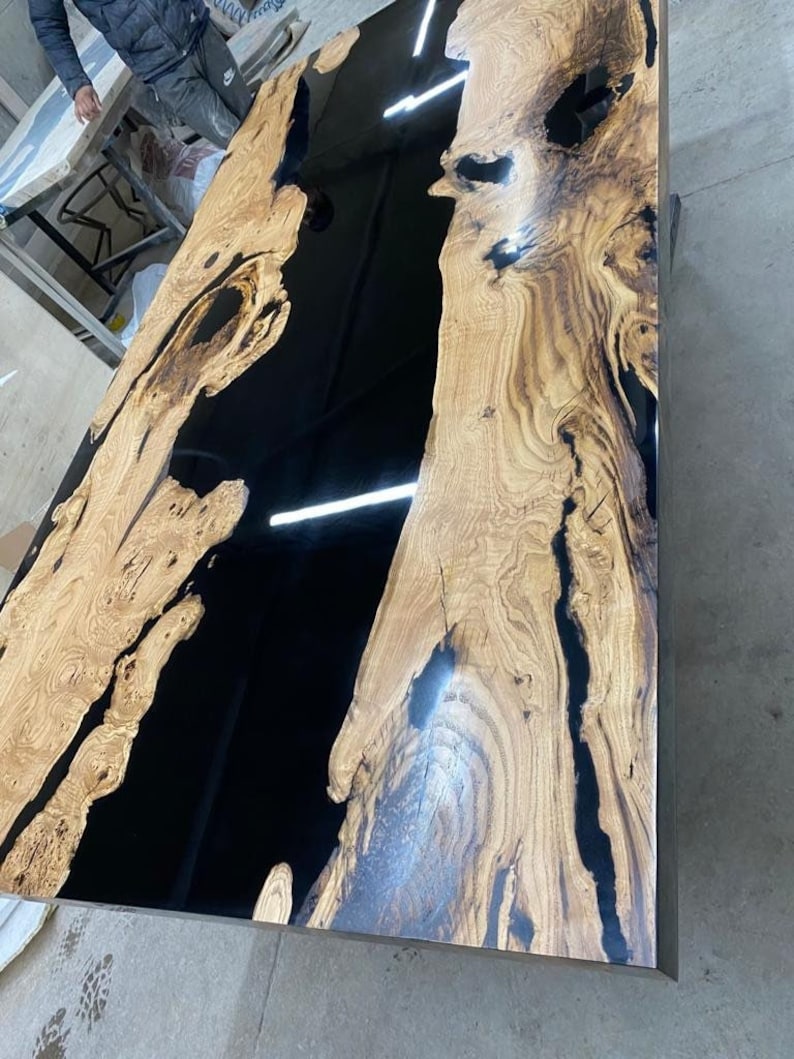 Resin table with a mirrored or reflective surface