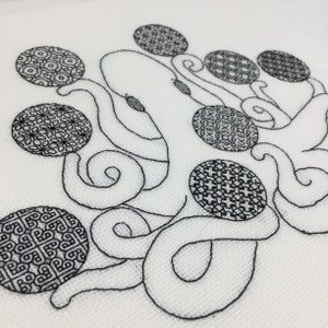 May include: Black and white embroidered design of an octopus with eight tentacles and eight circular patterned elements.