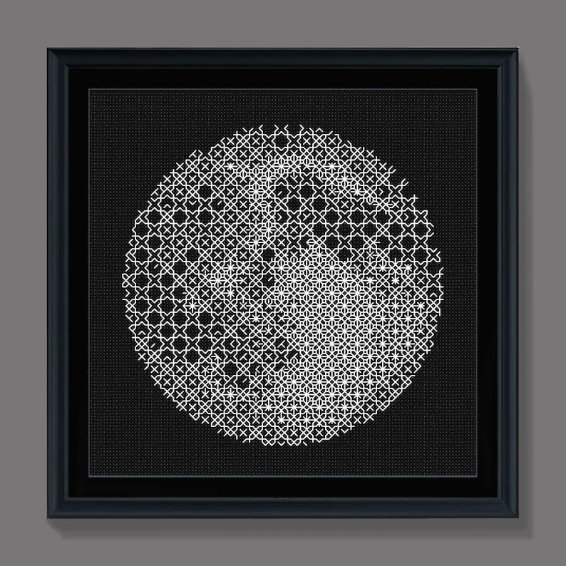 May include: A black and white framed artwork featuring a circular design with a geometric pattern. The design is made up of white lines on a black background.