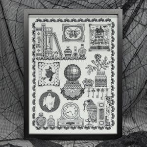 May include: Black and white cross-stitch design featuring a variety of spooky and whimsical elements, including a witch, a ghost, a raven, a clock, a crystal ball, a house, and a book. The design is framed in a black frame.