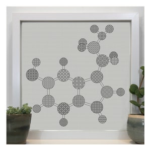 May include: A black and white cross-stitch pattern of a molecule with a geometric design. The molecule is framed in a white frame.