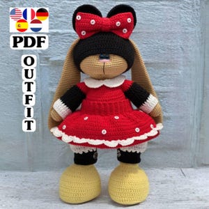 May include: A crocheted bunny doll wearing a red dress with white polka dots, a black cap with a red bow, and yellow shoes. The doll has long, tan ears and is wearing a white-collared dress. The text "PDF OUTFIT" is visible.
