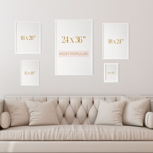 May include: Five white picture frames with different sizes and dimensions displayed on a white wall. The frames are arranged in a staggered pattern. The largest frame is in the center and has the text "24 x 36" and "MOST POPULAR" written in gold. The other frames have the dimensions "16 x 20", "18 x 24", and "12 x 18" written in gold.