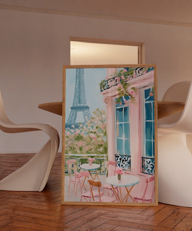 May include: A painting of a Parisian cafe with pink walls and a view of the Eiffel Tower. The cafe has tables and chairs with pink cushions. There are flowers on the tables and in the window boxes.