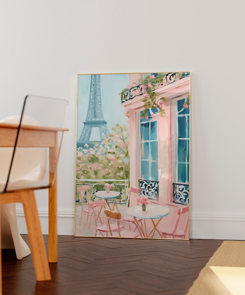 May include: A watercolor painting of a Parisian cafe with pink walls and a view of the Eiffel Tower. The cafe has tables and chairs set up outside, with pink flowers in pots.