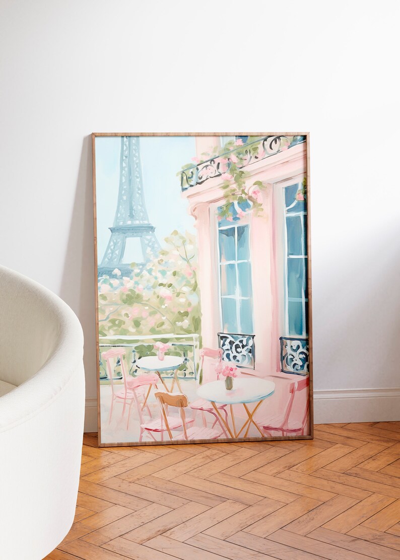 May include: A painting of a Parisian cafe with pink walls and a view of the Eiffel Tower. The cafe has tables and chairs on the balcony, with flowers in vases on the tables.