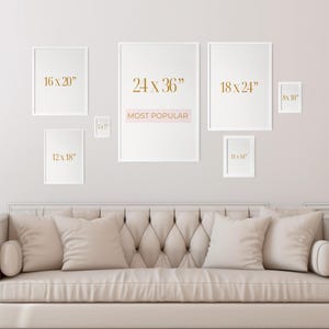 May include: A display of framed art prints in various sizes, including 16 x 20 inches, 24 x 36 inches, 18 x 24 inches, 8 x 10 inches, 12 x 18 inches, and 11 x 14 inches. The text "MOST POPULAR" is displayed on one of the frames. The frames are mounted on a light-colored wall above a beige sofa.