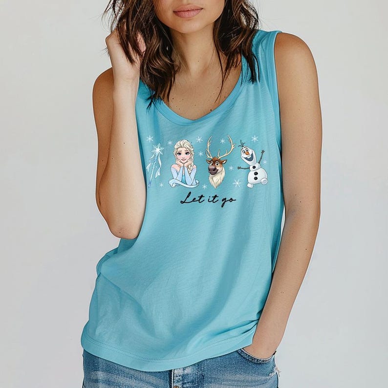 May include: A light blue tank top featuring a graphic of characters from the movie Frozen: Elsa, Sven, and Olaf. The text "Let it go" is written below the characters. The tank top has a scoop neck.