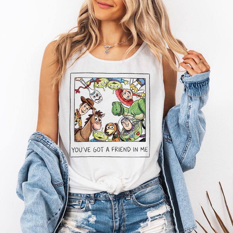 May include: White vest top with a framed graphic of Toy Story characters, including Woody, Buzz Lightyear, and the Little Green Men. The text "YOU'VE GOT A FRIEND IN ME" is printed below the image.
