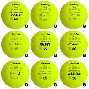 May include: Nine yellow pickleballs with black text. Each ball has "Happy Birthday" and a name, with an age. Names include Paul, Michelle, Patrick, Sidney, Riley, Jeanie, Sarah, Samantha, and William. The ages range from 35 to 70.
