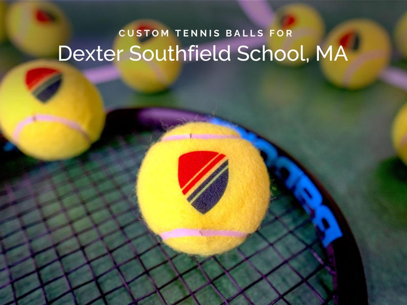 May include: Yellow tennis balls with a custom logo featuring a red, black, and blue shield design. The text "Dexter Southfield School, MA" is printed above the balls.