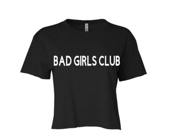 May include: Black cropped t-shirt with white text that reads "BAD GIRLS CLUB".