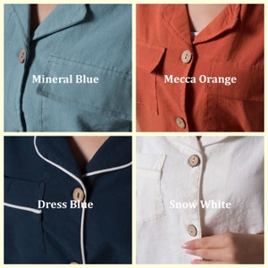 May include: Four different colored shirts with button closures. The shirts are in the colors mineral blue, dress blue, mecca orange, and snow white.