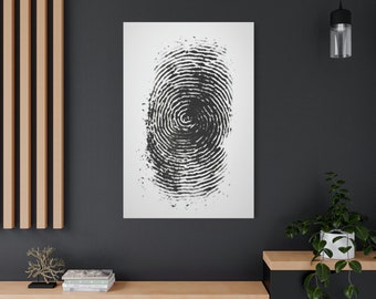 May include: A black and white fingerprint art print on a white canvas. The fingerprint is centered and detailed, showcasing the unique pattern of ridges and whorls. The artwork is displayed on a dark gray wall, adding a modern touch to the decor.