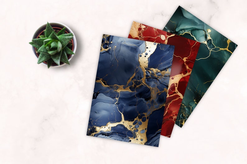 May include: Three sheets of paper with abstract marbled designs in blue, red, and green with gold accents. The sheets are stacked on top of each other.