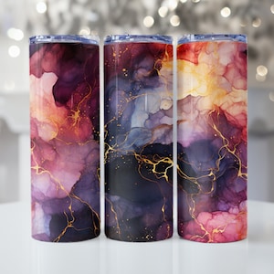 May include: Three stainless steel tumblers with a colorful abstract design. The tumblers feature a swirling pattern of pink, purple, blue, and gold.