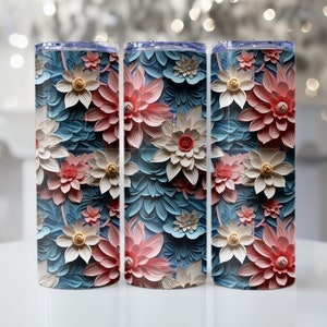 May include: Three stainless steel tumblers with a floral design. The tumblers feature a blue background with pink and white flowers.