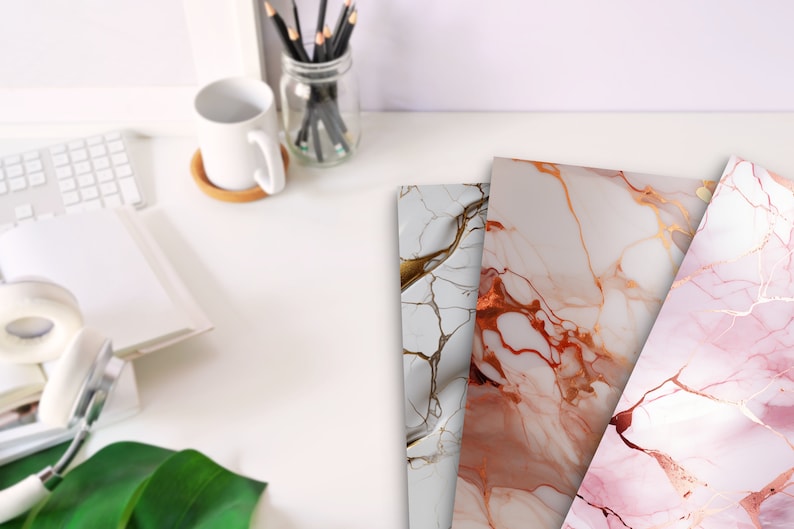 May include: Three sheets of decorative paper with a marble pattern. The paper has a white background with gold and pink veins. The paper is perfect for crafting, scrapbooking, and other creative projects.