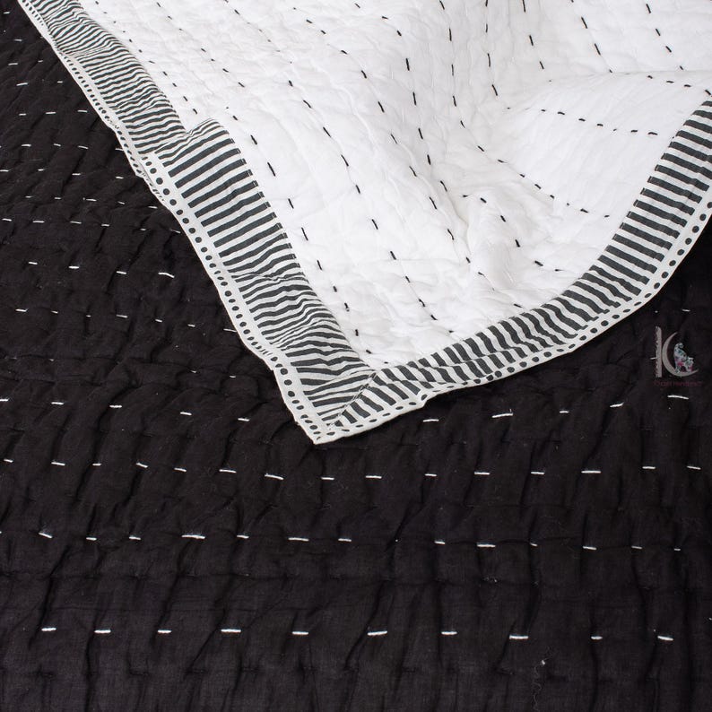 handstitched Kantha pattern on a solid black, lightweight Indian cotton quilt