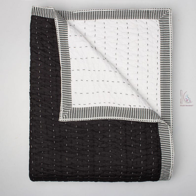 reversible solid black Kantha quilt, highlighting the subtle textural pattern created by the handstitching