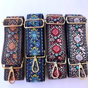 May include: Four colourful woven fabric straps with gold metal clasps. The straps have a floral pattern and are suitable for bags or purses.