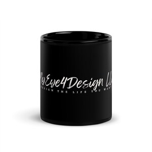 May include: A solid black ceramic mug featuring white text that reads MyEye4Design LLC in a script font, with the additional text DESIGN THE LIFE YOU WANT printed in a smaller, clean sans-serif font directly underneath the main logo.