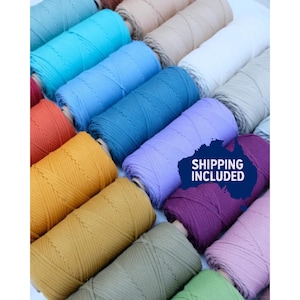 May include: An assortment of macrame cord spools in a range of colours, such as blue, yellow, purple, and pink. The spools are arranged to display the different colours and textures of the cord. The image includes the text "SHIPPING INCLUDED".