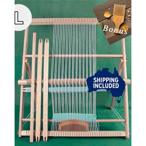 May include: A wooden weaving loom with white warp threads and a partially woven teal weft. Includes a wooden comb, two shuttles, and a bonus wooden weaving tool. The loom is set against a green background.