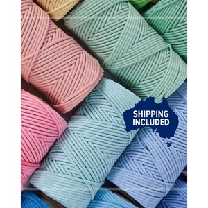 May include: A selection of colourful macrame cord spools in shades of pink, blue, green, and yellow. The cord is tightly wound, showing the texture of the material. The image has a diagonal arrangement.