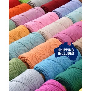 May include: An assortment of colourful macrame cords in shades like orange, pink, blue, and green. The cords are neatly rolled, displaying a range of hues suitable for crafting. The image is well-lit, emphasising the texture and colours of the materials.