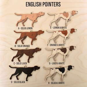 May include: Eight wooden English Pointer dog ornaments in various colours, including solid lemon, solid orange, solid liver, solid black, lemon and white, orange and white, liver and white, and black and white. Each ornament has a letter and description of the colour combination.