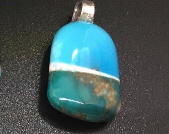 May include: A blue and green gemstone pendant with a silver bail. The gemstone has a white line across the middle.