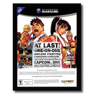 May include: A video game advertisement for Capcom vs. SNK 2 EO on the Nintendo GameCube. The ad features a red, white, and blue color scheme with images of characters from the game. The text on the ad reads "At Last! One-on-One Arcade Fighting on Nintendo GameCube."  "From Two of Your Favorite Worlds: Capcom vs. SNK."  "Over 44 Challengers - 6 Game Modes."  "Extreme Offense Delivers Instant Devastation."