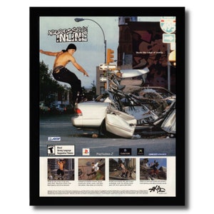 May include: A video game advertisement for Aggressive Inline, a skateboarding game for the PlayStation 2, Xbox, and Game Boy Advance. The ad features a skater performing a trick over a wrecked car in a city street. The text "Skate the edge of sanity" is visible in the background.