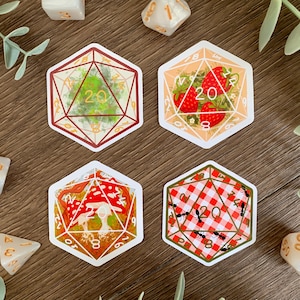 May include: Four hexagonal stickers featuring 20-sided die designs. One shows a green abstract pattern, one displays red strawberries, one depicts red and white mushrooms, and one features a red and white checkered pattern with black ants.