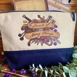 May include: A beige canvas pouch with a blue bottom. The pouch has a zipper closure and features a colorful illustration of a sword, rope, dice, and arrows with the text "Pouch of Many Things".