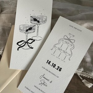 May include: Save the date card with a black and white illustration of champagne glasses and the text "Save the Date", "14.10.26", "For the wedding of Joanne & Steve", "Hedsor House", and "Formal invitation to follow".