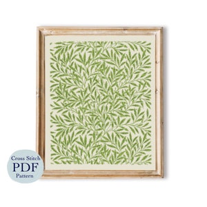 May include: A framed cross stitch pattern featuring a green and white willow pattern. The pattern is in a wooden frame with a white mat.