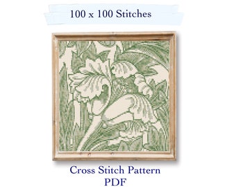May include: A cross stitch pattern featuring a floral design with green leaves and white flowers. The pattern is framed in a wooden frame and has the text "100 x 100 Stitches" and "Cross Stitch Pattern PDF" below the image.