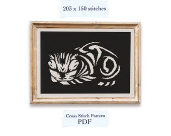 May include: Cross stitch pattern PDF for a black and white stylised illustration of a sleeping cat. The pattern is 203 x 150 stitches.