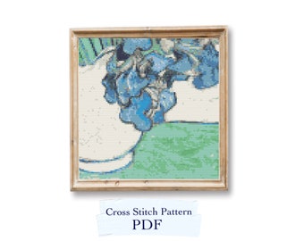 May include: A cross stitch pattern of a blue flower in a vase, framed in a wooden frame. The pattern is available as a PDF download. Cross Stitch Pattern PDF