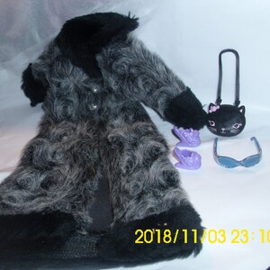May include: A black and gray faux fur coat with a black collar and cuffs. The coat is paired with a black purse with a cat face design, purple shoes, and blue sunglasses.