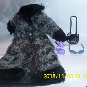 May include: A black and gray faux fur coat with a black collar and cuffs. The coat is paired with a black purse with a cat face design, purple shoes, and blue sunglasses.