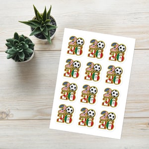 May include: A sheet of stickers featuring a soccer ball and the text "World Cup 2026". The stickers incorporate the flags of the United States, Mexico, and Canada. The stickers are white with colorful graphics.